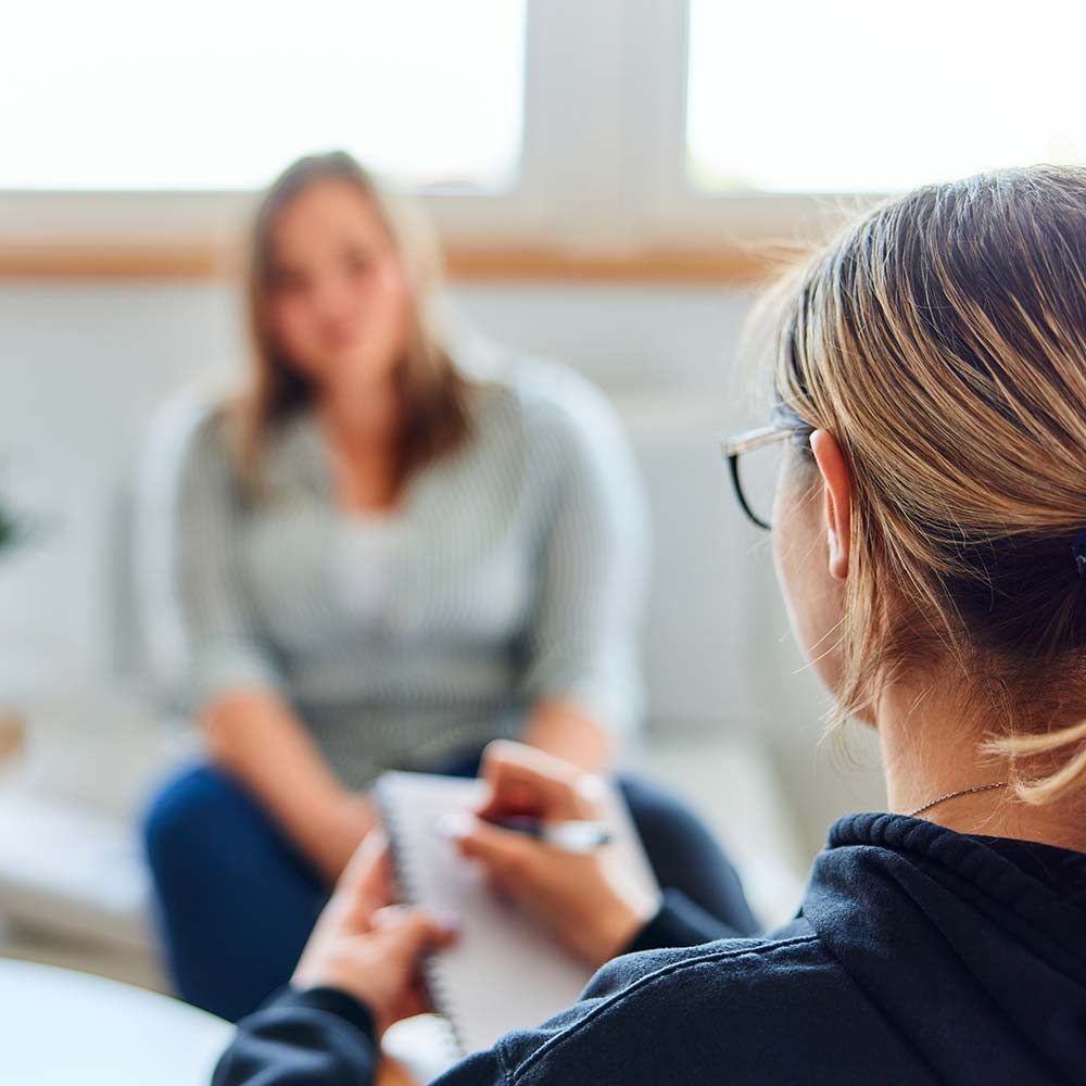 Therapist speaking to unrecognizable patient
