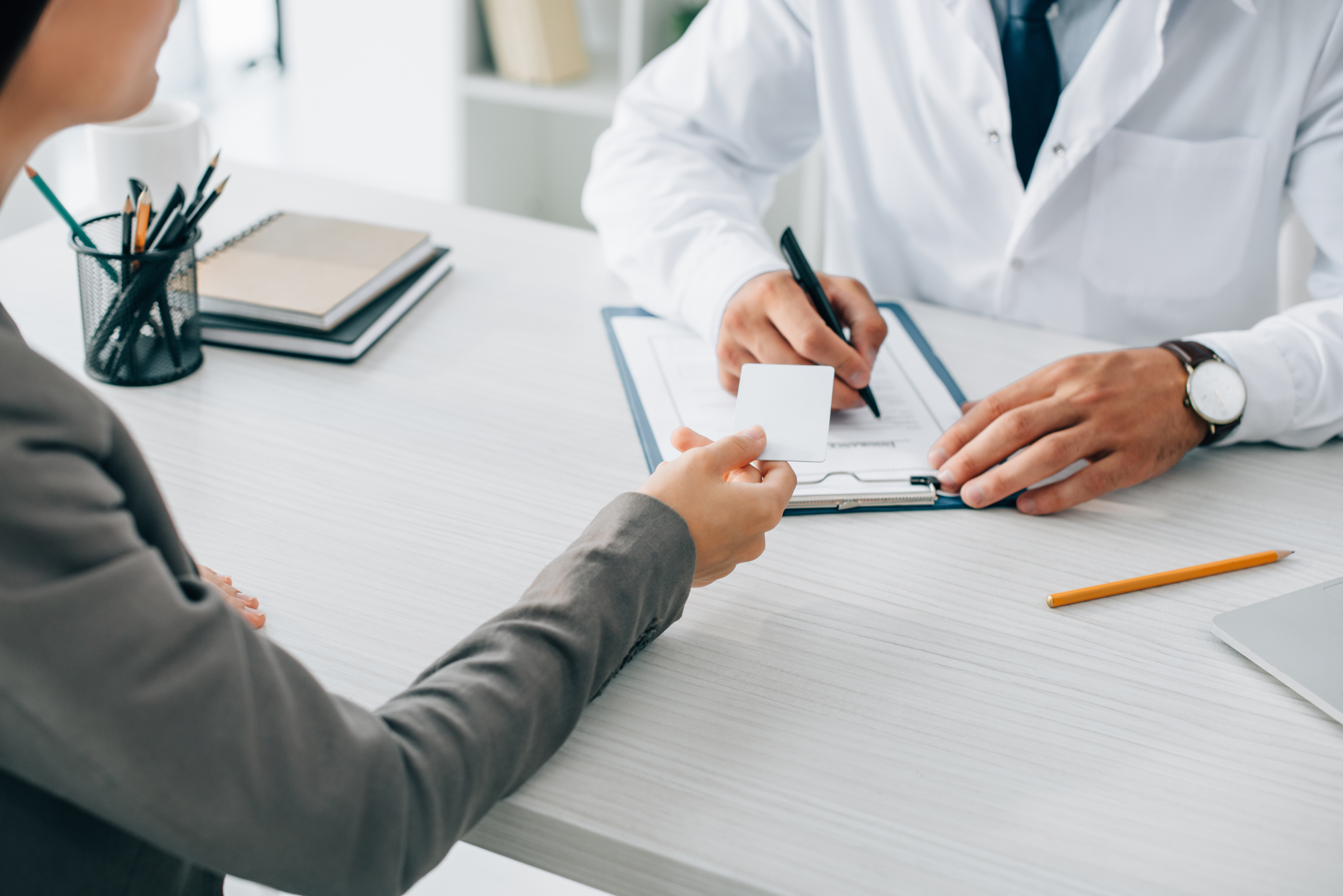 Person reviewing a Highmark insurance card to identify their specific plan for rehab coverage
